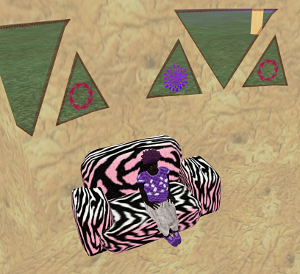 Shaka sits on her pink, zebra skin loveseat underneath a wall full of one-way windows
