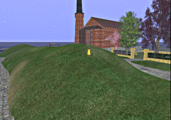 Iyoba stands on a hill behind the Brunel Engine House
